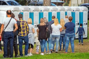 line of people in a porta potties